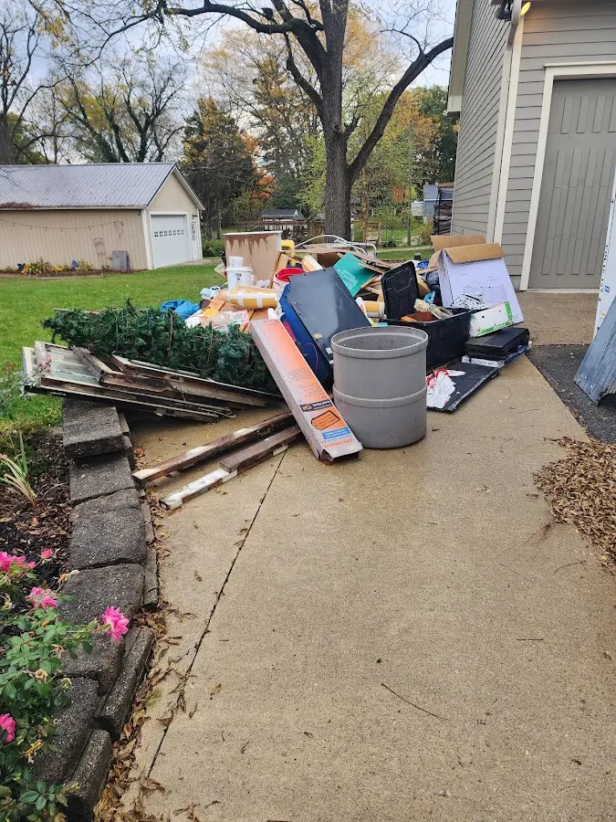 Dumpster being loaded with debris for Commercial Dumpster Rental in Cedar Park